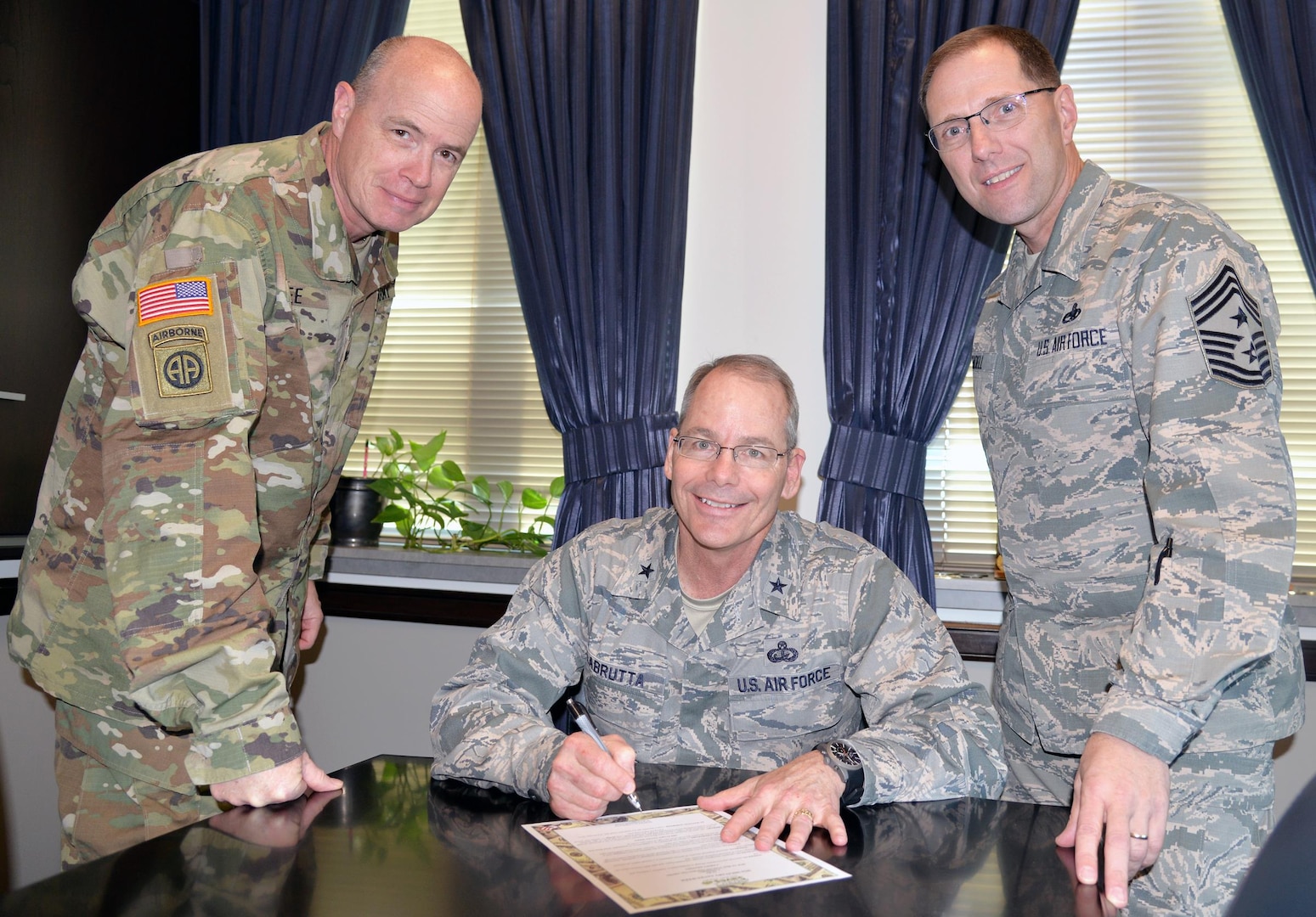 From left: Army Col. Mark A. Lee, 502nd Air Base Wing and Joint Base San Antonio vice commander; Brig. Gen. Bob LaBrutta, 502nd ABW and JBSA commander; and Command Chief Master Sgt. Stanley C. Cadell, 502nd ABW and JBSA Command Chief, sign the Military Saves Pledge to “Set A Goal. Make a Plan. Save Automatically.” Military Saves Week begins Monday and runs through Feb. 26 throughout JBSA. The pledge is a commitment to exercise good financial habits, improve financial readiness and encourage other Americans to do the same.