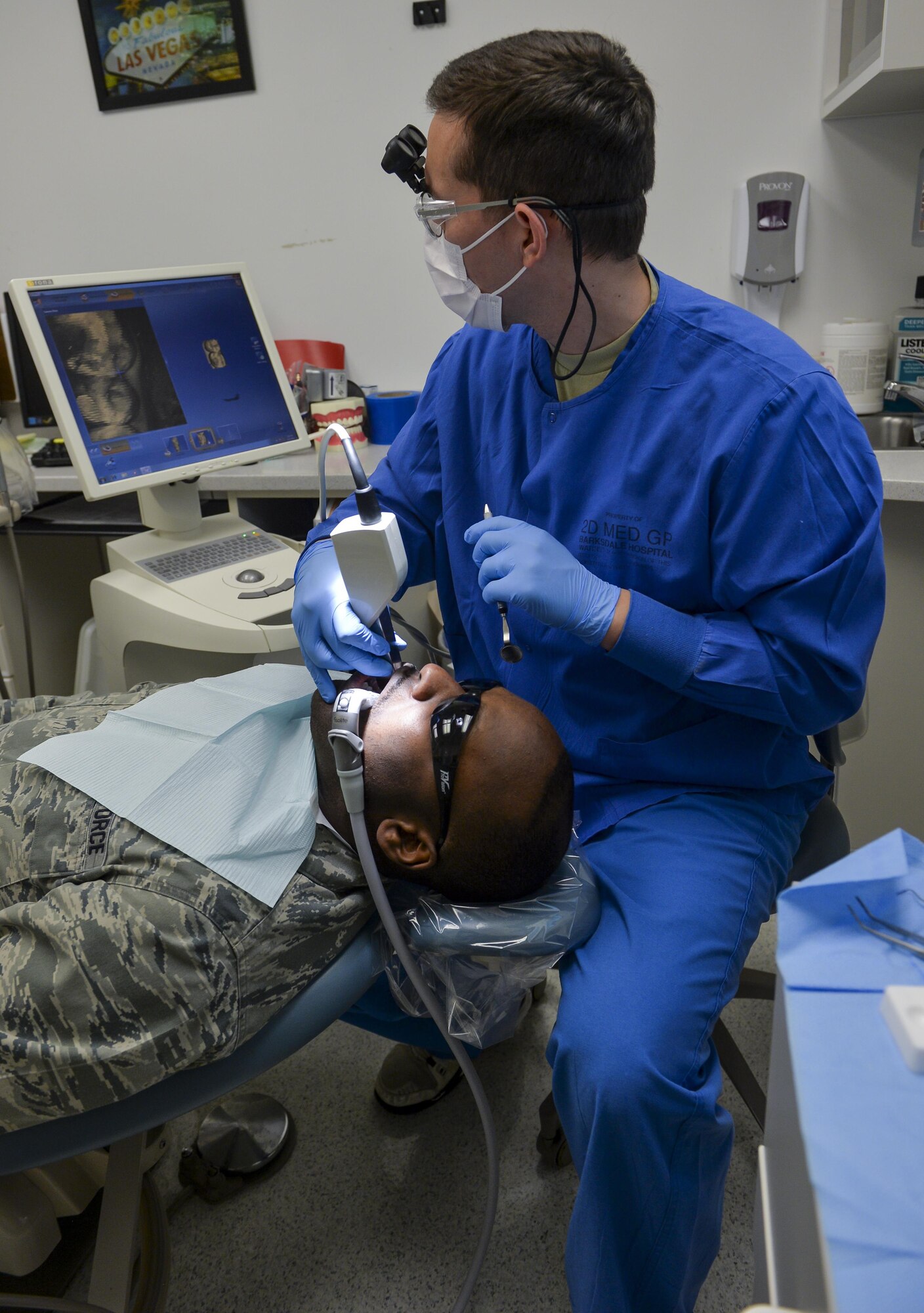Capt. (Dr.) Derek Sloan, 2nd Dental Squadron general dentist, takes an optical impression during an exam at Barksdale Air Force Base, La., Feb. 12, 2016. Optical impressions replaced the old wet impression, process decreasing the time needed to create a physical cast. The new process reduced completion of crowns from two weeks to approximately two hours. (U.S. Air Force photo/Airman 1st Class Mozer O. Da Cunha)