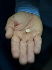 Denny Shaffer, 2nd Dental Squadron laboratory technician, presents a completed crown at Barksdale Air Force Base, La., Feb. 12, 2016. Crowns are used for patients cases where damage covers over 70 percent of a tooth’s width. Fillings can be used for less severe cases at the dentist’s discretion. (U.S. Air Force photo/Airman 1st Class Mozer O. Da Cunha)