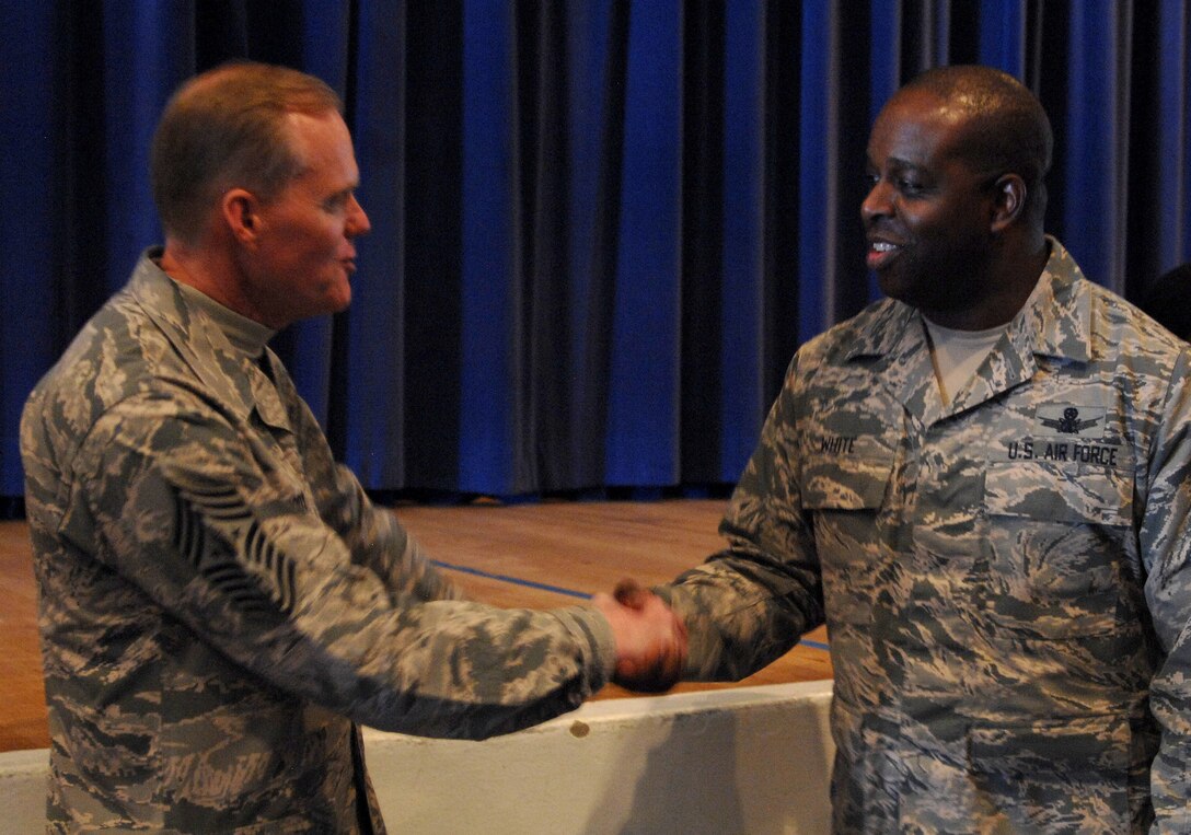 Chief Master Sgt. of the Air Force James A. Cody shakes hands with Master Sgt. Carlo White, of the 3rd Space Operations Squadron from Schriever Air Force Base, Colo., Feb. 11, 2016, after the NCO all call at the Peterson AFB auditorium. NCOs from the North American Air Defense Command, U.S. Northern Command and nearby bases completely filled the 300-plus person venue. (U.S. Air Force photo/Master Sgt. Chuck Marsh)