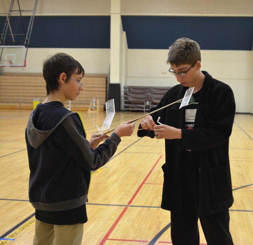 ALBUQUERQUE, N.M. – Two students prepare their plane to fly in the Wright Stuff event at the 2016 Central New Mexico Science Olympiad at the University of New Mexico, Jan. 30, 2016.