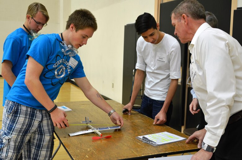 ALBUQUERQUE, N.M. – A student measures his plane to show Wright Stuff event judge Reginald Bourgeois, right, that it’s within the specified guidelines, Jan. 30, 2016. 
