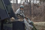 OSAN AIR BASE, South Korea (Feb. 16, 2016) - Pfc. Eli Schaap, an air defense battle management system operator assigned to E Battery, 6th Battalion, 52nd Air Defense Artillery Regiment, hands off a M134 Stinger Missile to Pvt. Imaris Suarez during a readiness drill.  The Soldiers are stationed at Camp Casey, South Korea and are conducting a cross-training exercise with Patriot air defense forces across the peninsula. 