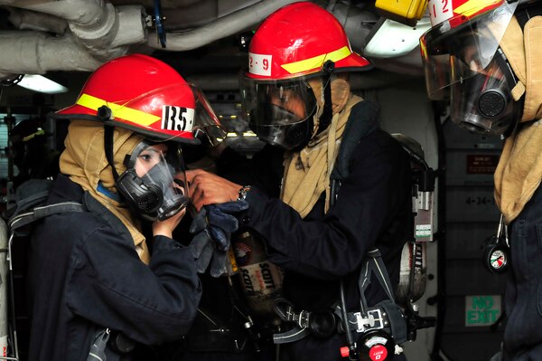 YOKOSUKA, Japan (Feb. 11, 2016) Damage Controlman Fireman Daniel Mcneil,right, attached to the U.S. 7th Fleet flagship USS Blue Ridge (LCC 19), helps Damage Controlman Fireman Jessica Closser don a Self Contained Breathing Apparatus (SCBA) mask during a drill. Blue Ridge is currently moored at Commander, Fleet Activities Yokosuka, finishing the final preparations for its 2016 patrol cycle. 