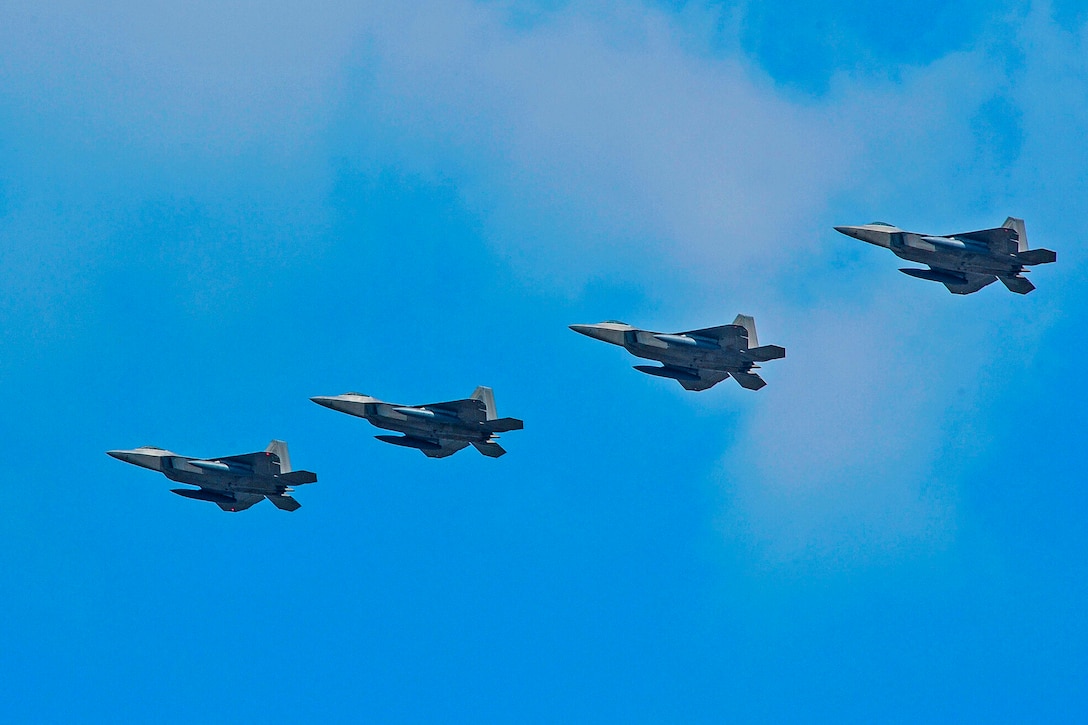 Four U.S. Air Force F-22 Raptor fighter aircraft from Kadena Air Base, Japan, fly over Osan Air Base, South Korea, Feb. 17, 2016. The Raptors were joined by four F-15 Slam Eagles and U.S. Air Force F-16 Fighting Falcons in response to recent provocative action by North Korea. Air Force photo by Song  Kyong-hwan