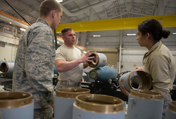 Senior Airman Ben Guthals, 57th Maintenance Squadron munitions systems journeyman, guides 2nd Lt. Thomas Tincher and 2nd Lt. Amanda Ryder, 366th Equipment Maintenance Squadron crew members, through the process of assembling guided bomb unit-12 Paveway IIs, Feb. 8, 2016, at Mountain Home Air Force Base, Idaho. The GBU-12s were used during a F-35A Lightning II deployment test at the nearby range complex. (U.S. Air Force photo by Airman Chester Mientkiewicz/RELEASED)