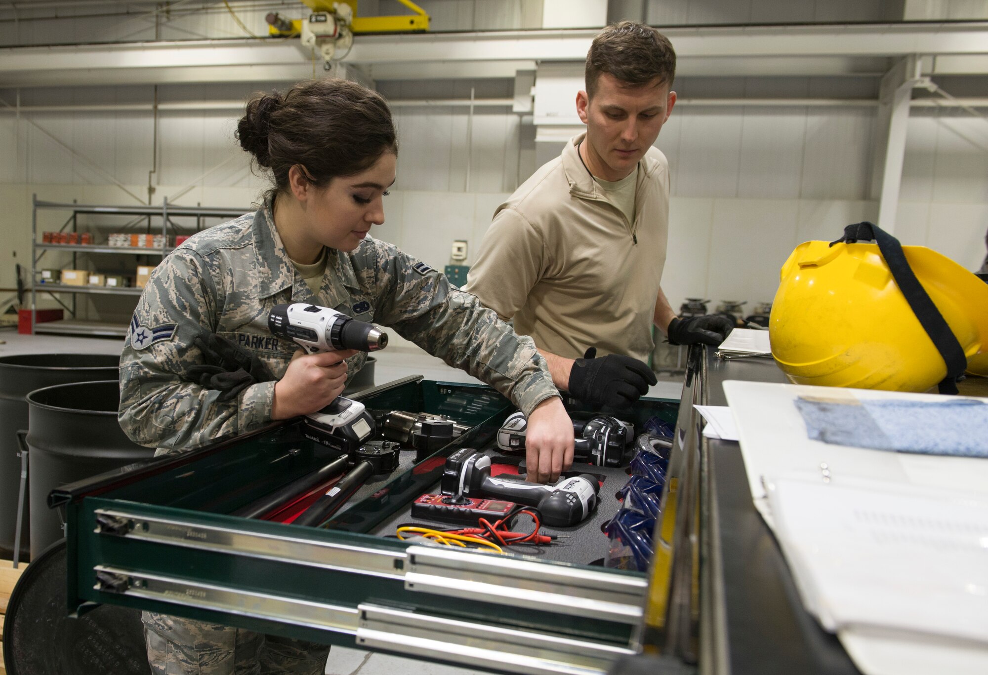 Staff Sgt. Nick Olmsted, 366th Equipment Maintenance Squadron crew chief, and Airman 1st Class Rachel Parker, 366th EMS crew member, gather tools needed to assemble guided bomb unit-12 Paveway IIs, Feb. 8, 2016, at Mountain Home Air Force Base, Idaho. The GBU-12s were assembled to be used during an initial operating capability test for the F-35A Lightning IIs. (U.S. Air Force Photo by Airman Chester Mientkiewicz/RELEASED)