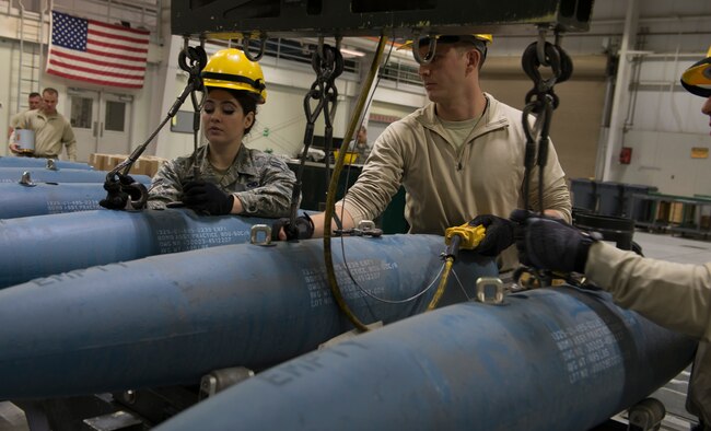 Staff Sgt. Nick Olmsted, 366th Equipment Maintenance Squadron crew chief, and Airman 1st Class Rachel Parker, 366th EMS crew member, unhook guided bomb unit-12 Paveway IIs from a crane, Feb. 8, 2016, at Mountain Home Air Force Base, Idaho. Members of the 366th EMS assembled GBU-12s to be used by the F-35A Lightning IIs during their first simulated deployment currently underway at Mountain Home AFB. (U.S. Air Force photo by Airman Chester Mientkiewicz/RELEASED) 