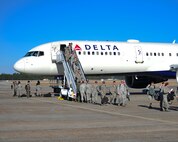 Members of Team Tyndall unload from a commercial airliner after arriving on the Tyndall Air Force Base, Fla., flightline Feb. 13, 2016. Approximately 130 aircraft and 3,000 personnel participated in exercise Red Flag 16-1, more than 200 of which were from Tyndall. (U.S. Air Force photo by Senior Airman Dustin Mullen/Released)