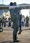 First Lt. Douglas Jolly Foss, 95th Fighter Squadron F-22 Raptor pilot, hugs his fiancée, Abby, Feb. 13, 2016, at the Tyndall Air Force Base, Fla., flightline. Foss proposed after arriving to Tyndall from Nellis Air Force Base, Nevada's Red Flag 16-1 exercise. (U.S. Air Force photo by Senior Airman Sergio A. Gamboa/Released)