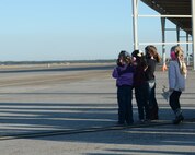 Children of Tyndall Airmen wait to see their parents return from Nellis Air Force Base, Nev., to Tyndall Air Force Base, Fla., Feb. 13, 2016. The families of the Airmen gathered at the flight line to see their loved ones after being on a temporary deployment for almost a month. (U.S. Air Force photo by Airman 1st Class Cody R. Miller/Released)