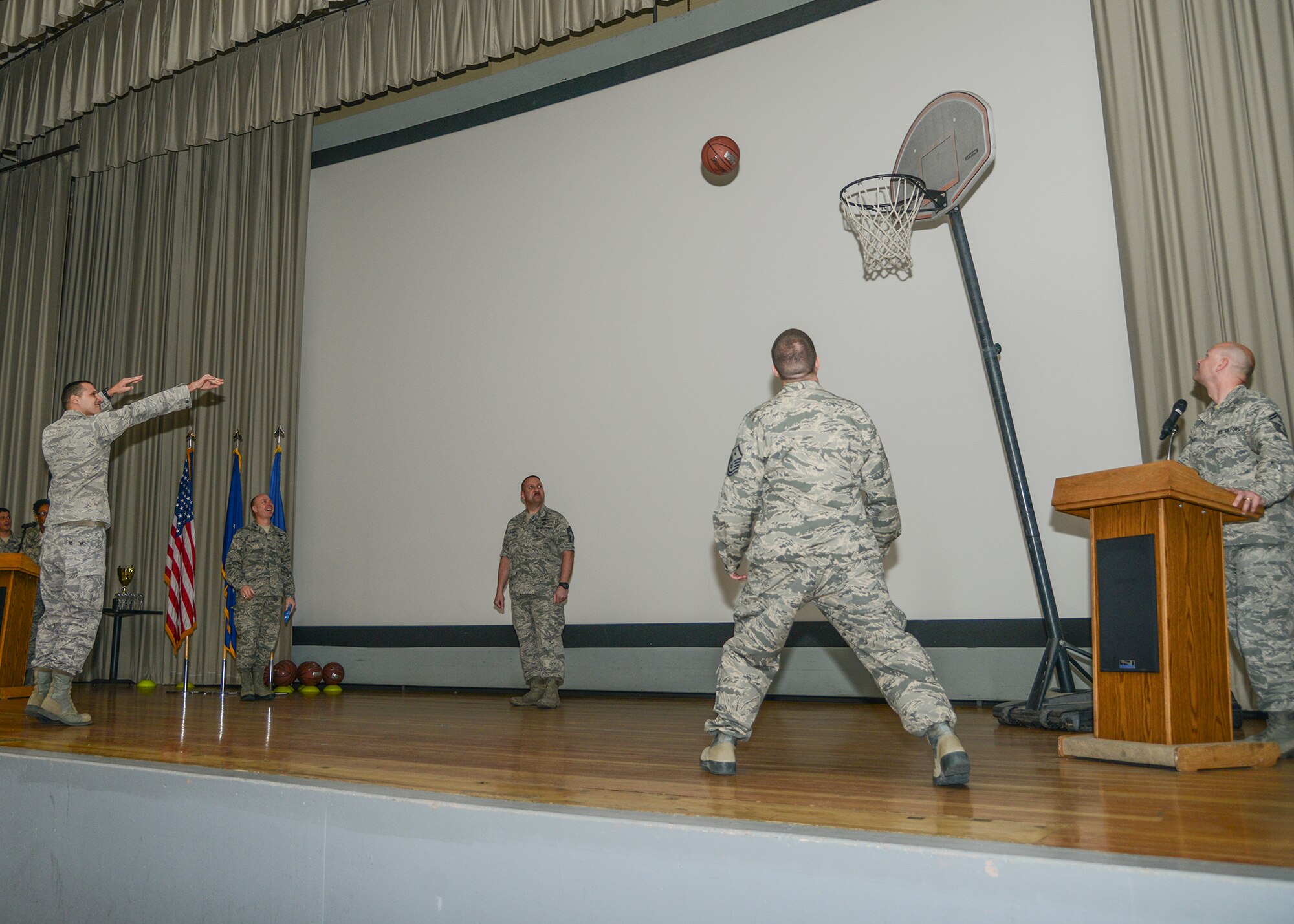 Like most test wing award ceremonies, the fourth quarter ceremony held in the base theater Feb. 11 had a theme. Winners received their award plaque from Brig. Gen. Carl Schaefer, 412th Test Wing commander, and were then given a basketball to shoot. (U.S. Air Force photo by Rebecca Amber)