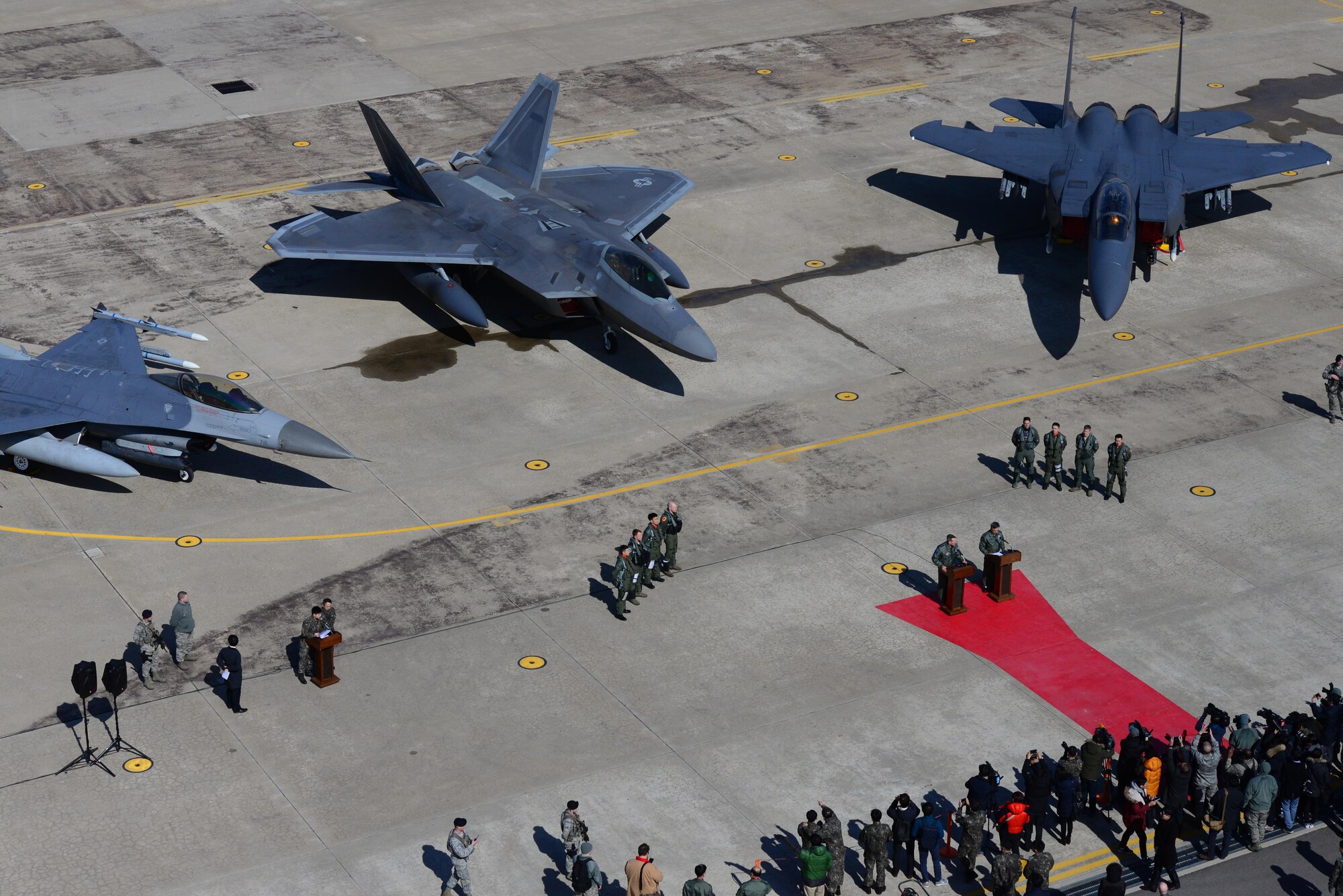 A U.S. Air Force F-22 Raptor from Kadena Air Base, Japan, is flanked by an F-16 Fighting Falcon and a South Korean air force F-15K Slam Eagle at Osan Air Base, South Korea, Feb. 17, 2016. The Raptor was part of a flyover formation of 12 aircraft demonstrating the strength of the U.S.-South Korea alliance in response to recent provocative actions by North Korea. (U.S. Air Force photo/Staff Sgt. Amber Grimm)