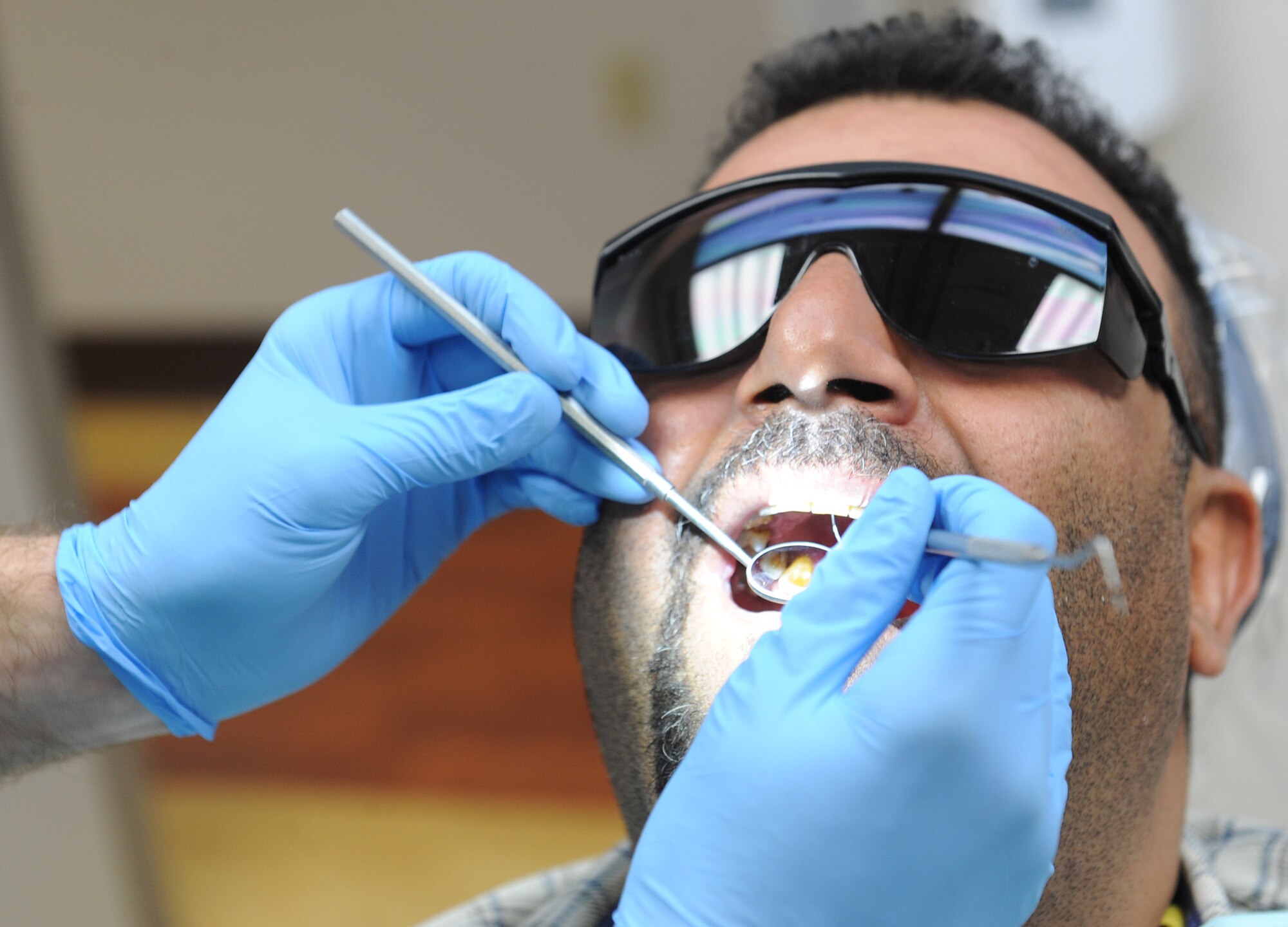 Capt. Dwayne Gentry, 22nd Aerospace Medicine Squadron general dentist, performs a check-up on Hasanain Abdulameer, an Iraqi national, Feb. 10, 2016, at McConnell Air Force Base, Kan. Gentry checked the tooth to make sure the infection was gone and there was no swelling. (U.S. Air Force photo/Senior Airman David Bernal Del Agua)