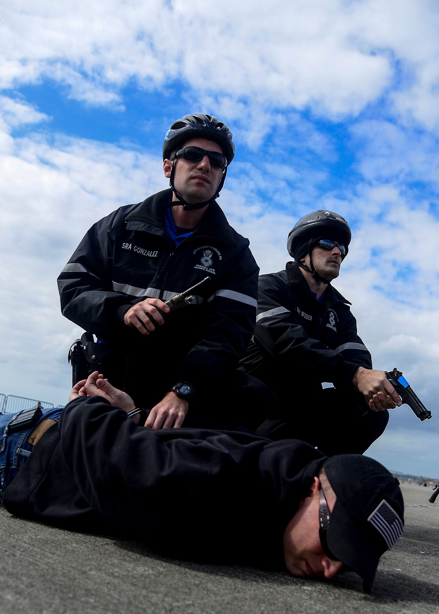 Senior Airman Christopher Gonzalez (left) and Staff Sgt. Aaron Roeder, marine patrolmen assigned to the 6th Security Forces Squadron, hold their position after apprehending the simulated active shooter during a major accident response exercise (MARE) at MacDill Air Force Base, Fla., Feb. 9, 2016. The MARE evaluated MacDill’s first responders’ ability to safely handle an active-shooter on the flightline. (U.S. Air Force photo by Staff Sgt. Melanie Hutto)  
