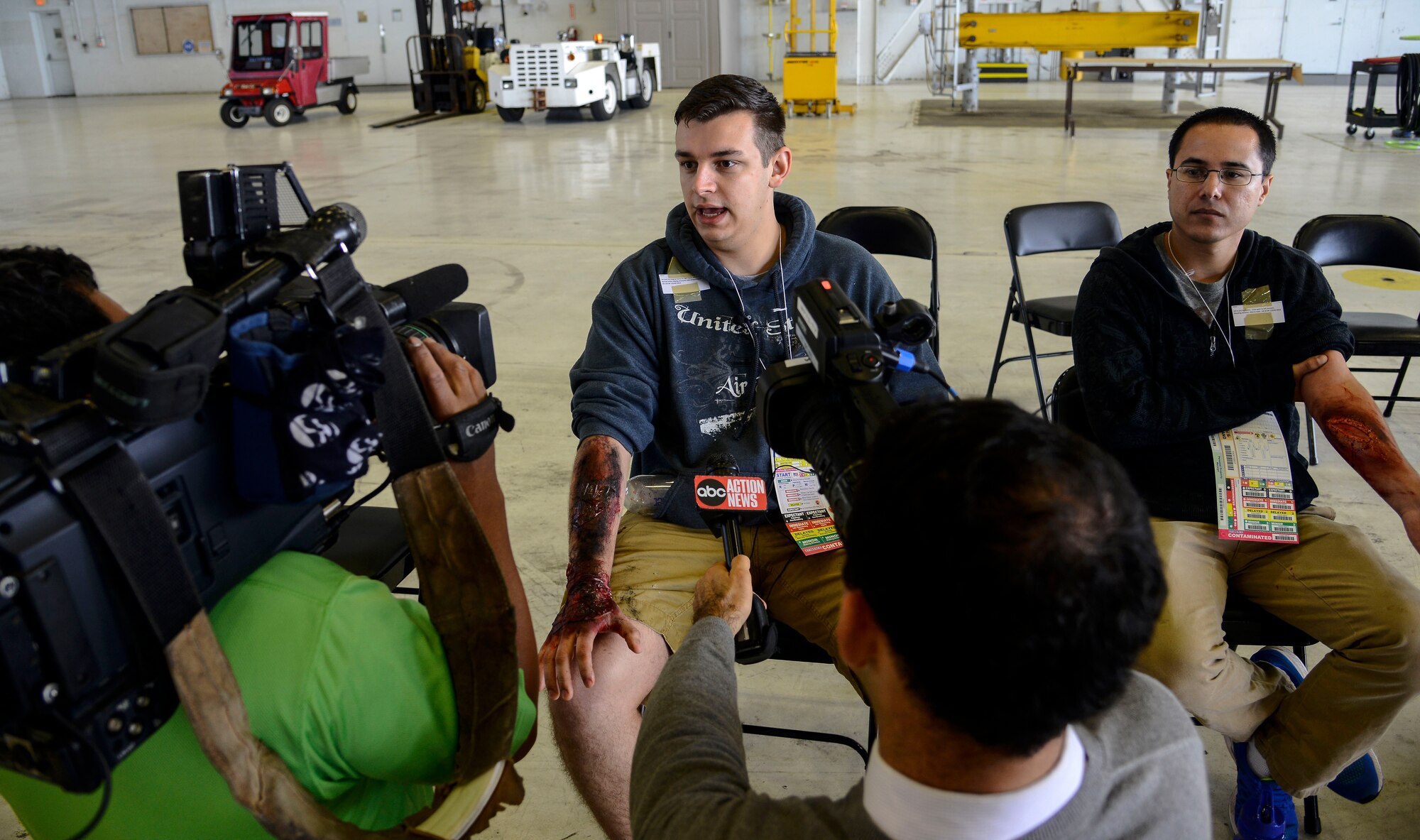An Airman with the 6th Air Mobility Wing is interviewed by local news channels during a major accident response exercise (MARE) at MacDill Air Force Base, Fla., Feb. 8, 2016. The MARE simulated an aircraft crash to prepare for any mishaps that may occur during the Tampa Bay Air Show scheduled to take place March 19 and 20. (U.S. Air Force photo by Staff Sgt. Melanie Hutto)