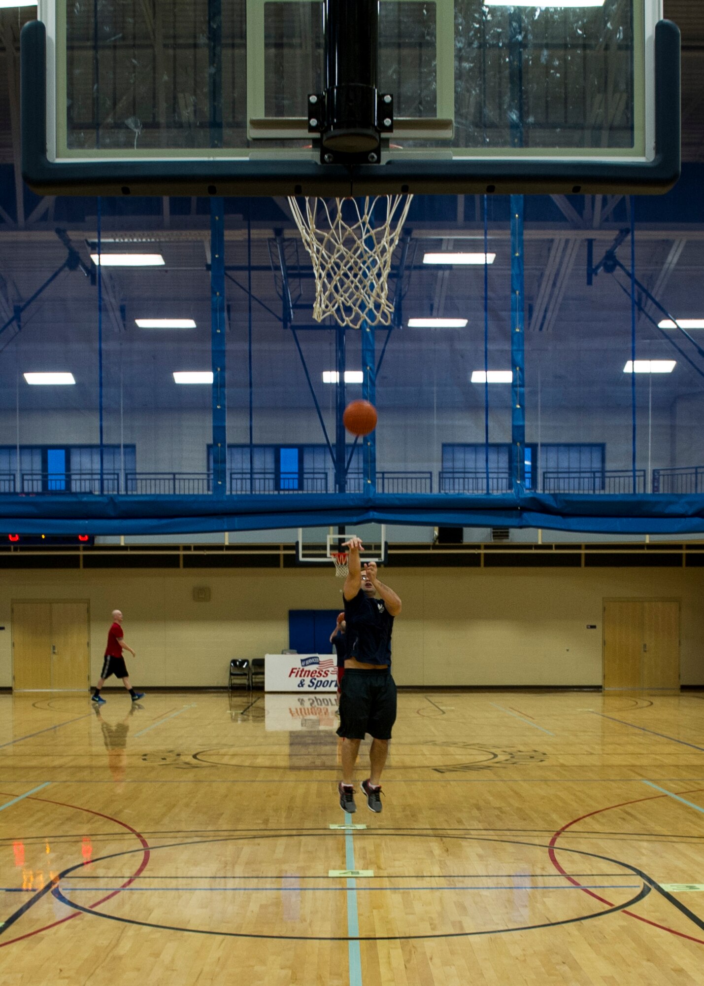 Tech Sgt. Lam Ho John, 92nd Contracting Squadron contracting specialist, shoots a basket while competing in the hot shot event during Winter Sports Day Feb. 12, 2016, at Fairchild Air Force Base, Wash. There were 212 teams made up of 862 Airmen participating in the various events of Winter Sports Day. (U.S. Air Force Photo/ Airman 1st Class Sean Campbell)