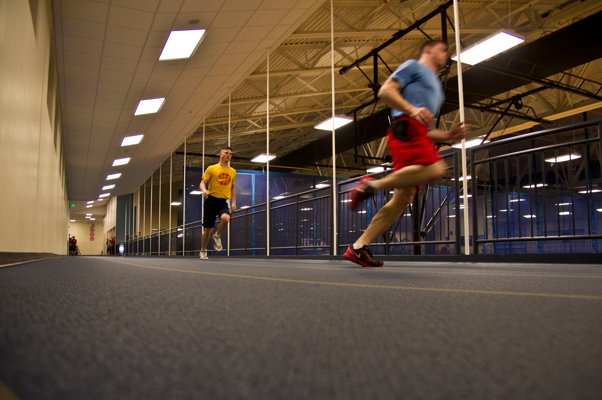 Team Fairchild members race around the indoor track during Winter Sports Day, Feb. 12, 2016, at Fairchild Air Force Base, Wash. Overall, there were 862 individuals participating, making up 212 teams.The day consisted of 13 events.They included hotshot, a relay race, doubles racquet ball, three on three basketball, blind volleyball, tug of war, cornhole, dodgeball, a boat race, wallyball, ultimate football, iron cross and a chili cook off. (U.S. Air Force Photo/ Airman 1st Class Nick J. Daniello)