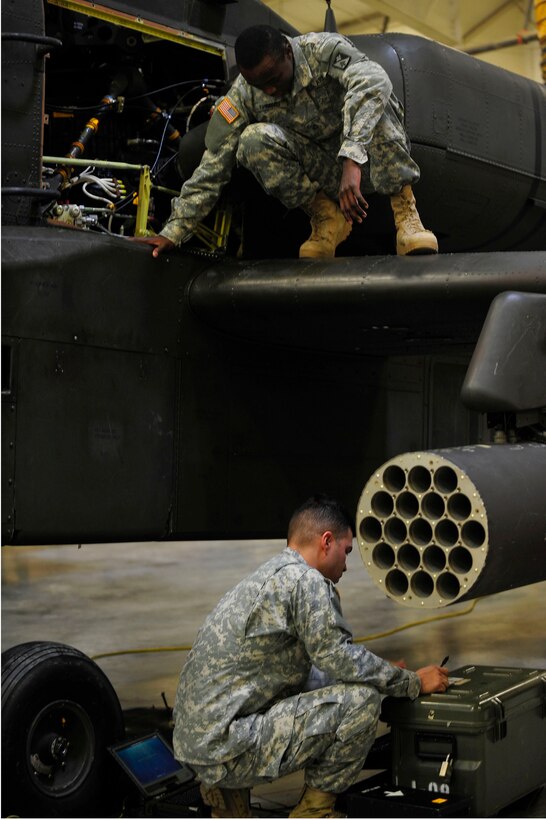 U.S. Soldiers from the 128th Aviation Brigade, 1st Battalion, 222nd Aviation Regiment, perform maintenance during an armament, electronic and avionics systems repair course at Fort Eustis, Va., Feb. 11, 2016. The course aims to teach aircraft electricians and maintainers how to replace broken or unusable aircraft parts. (U.S. Air Force photo by Airman 1st Class Breonna Veal)