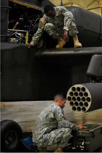 U.S. Soldiers from the 128th Aviation Brigade, 1st Battalion, 222nd Aviation Regiment, perform maintenance during an armament, electronic and avionics systems repair course at Fort Eustis, Va., Feb. 11, 2016. The course aims to teach aircraft electricians and maintainers how to replace broken or unusable aircraft parts. (U.S. Air Force photo by Airman 1st Class Breonna Veal)