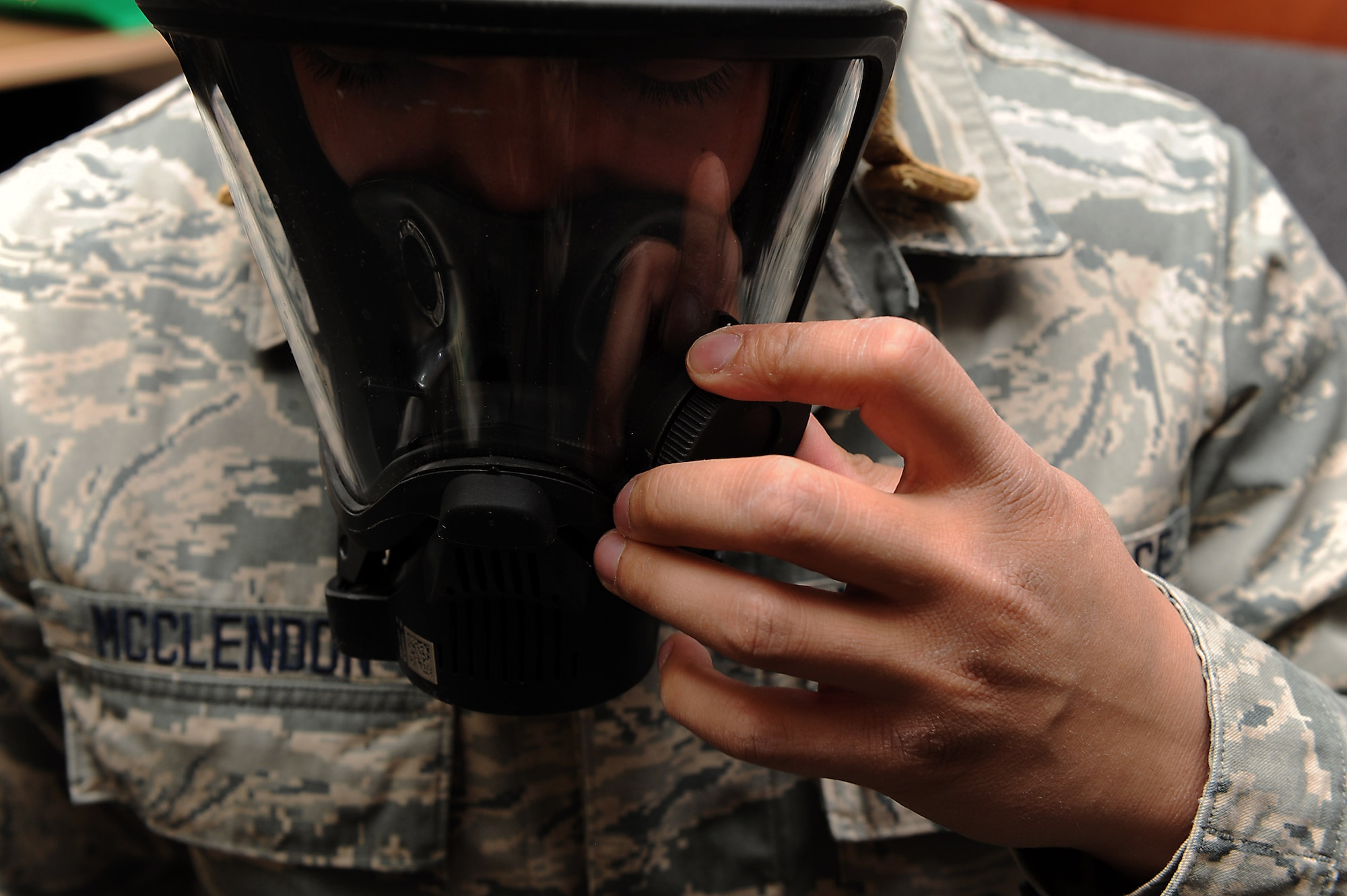 U.S Air Force Airman Alex McClendon, 633rd Aerospace Medicine Squadron bioenvironmental engineer technician, adjusts his Mine Safety Appliances FireHawk mask at Langley Air Force Base, Va., Feb. 9, 2016. Bioenvironmental personnel perform gas mask and respirator fit tests with a Portacount Pro+, which reads the particle count inside the mask versus outside of it, to ensure a proper seal to protect U.S. Service members from potentially hazardous chemicals. (U.S. Air Force photo by Senior Airman Brittany E. N. Murphy)