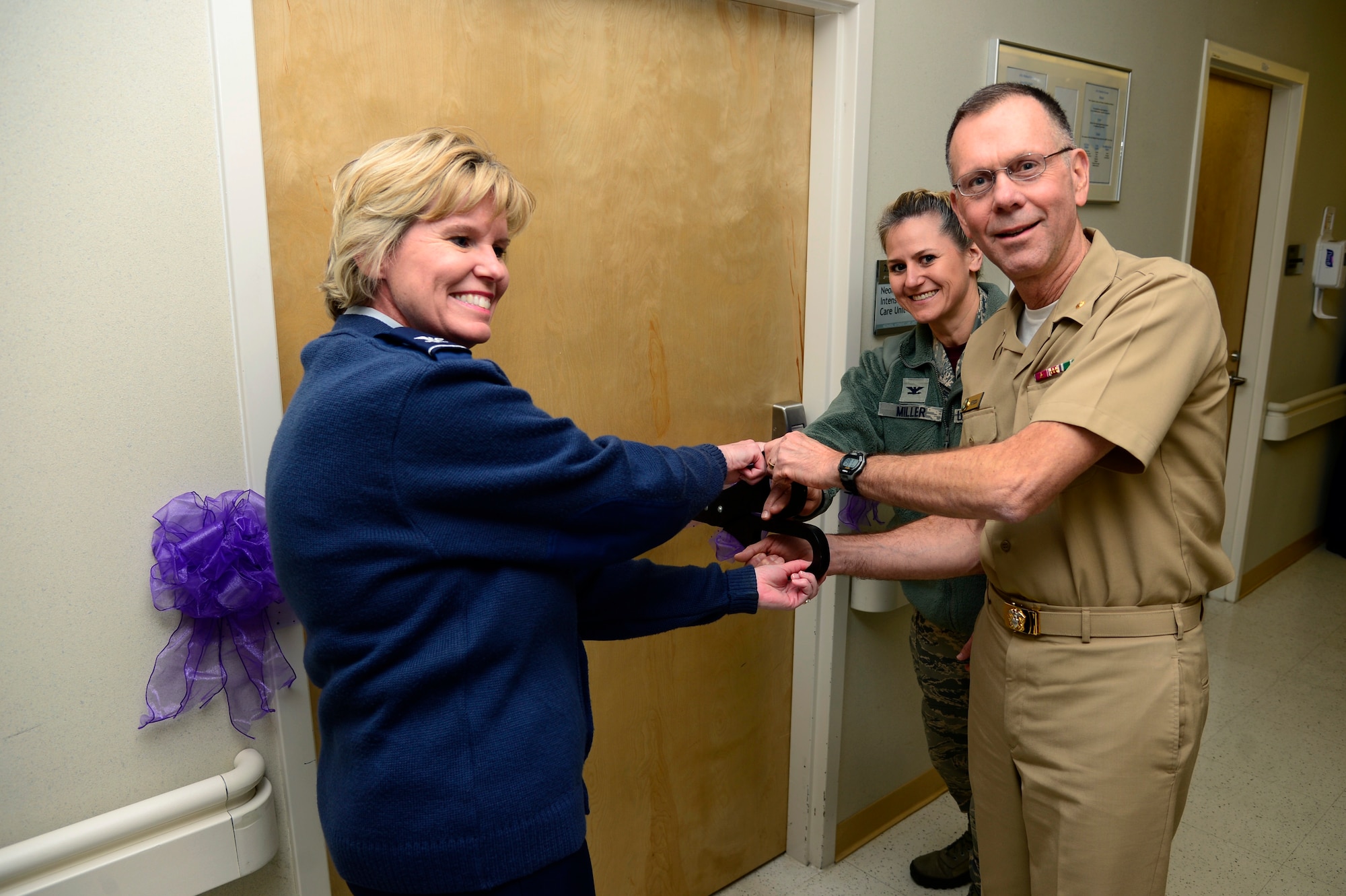 U.S. Navy Rear Adm. Kenneth Iverson, commander of Navy Medicine East and the Tidewater Enhanced Multi-service Market, center, U.S. Air Force Col. Susan Pietrykowski, 633rd Medical Group commander, left, and Col. Caroline M. Miller, 633rd Air Base Wing commander, cut the ribbon of the new level II Neonatal Intensive Care Unit (NICU) at Langley Air Force Base, Va., Feb. 12, 2016. Approximately 40 members of the NICU staff will use state-of-the-art equipment and evidence-based medicine to provide exceptional care to about a hundred delicate newborns and premature babies each year. (U.S. Air Force photo by Senior Airman Kayla Newman)