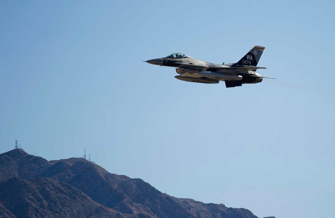 A 64th Aggressor Squadron F-16C Fighting Falcon flies over Nellis AFB, Nev., during Red Flag 16-1, Feb. 5, 2016. The aggressors act as high level advisories and replicate threats that Red Flag participants could see in an actual combat situation. (U.S. Air Force photo by Senior Airman Alex Fox Echols III/Released)  