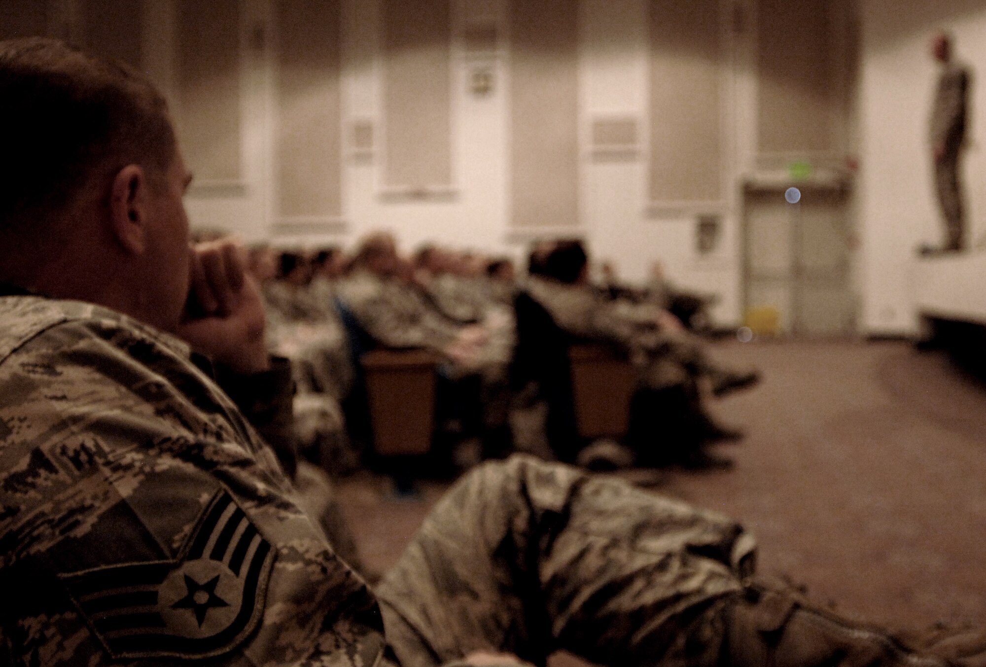 PETERSON AIR FORCE BASE, Colo. - A staff sergeant from Peterson Air Force Base listens intently to Chief Master Sgt. of the Air Force James Cody during the noncommissioned officer all call on February 11 at the Peterson AFB auditorium. NCOs from NORAD and USNORTHCOM, Peterson AFB, Schriever AFB and Cheyenne Mountain Air Force Station completely filled the 300-plus person venue. (U.S. Ai r Force photo by Master Sgt. Chuck Marsh)