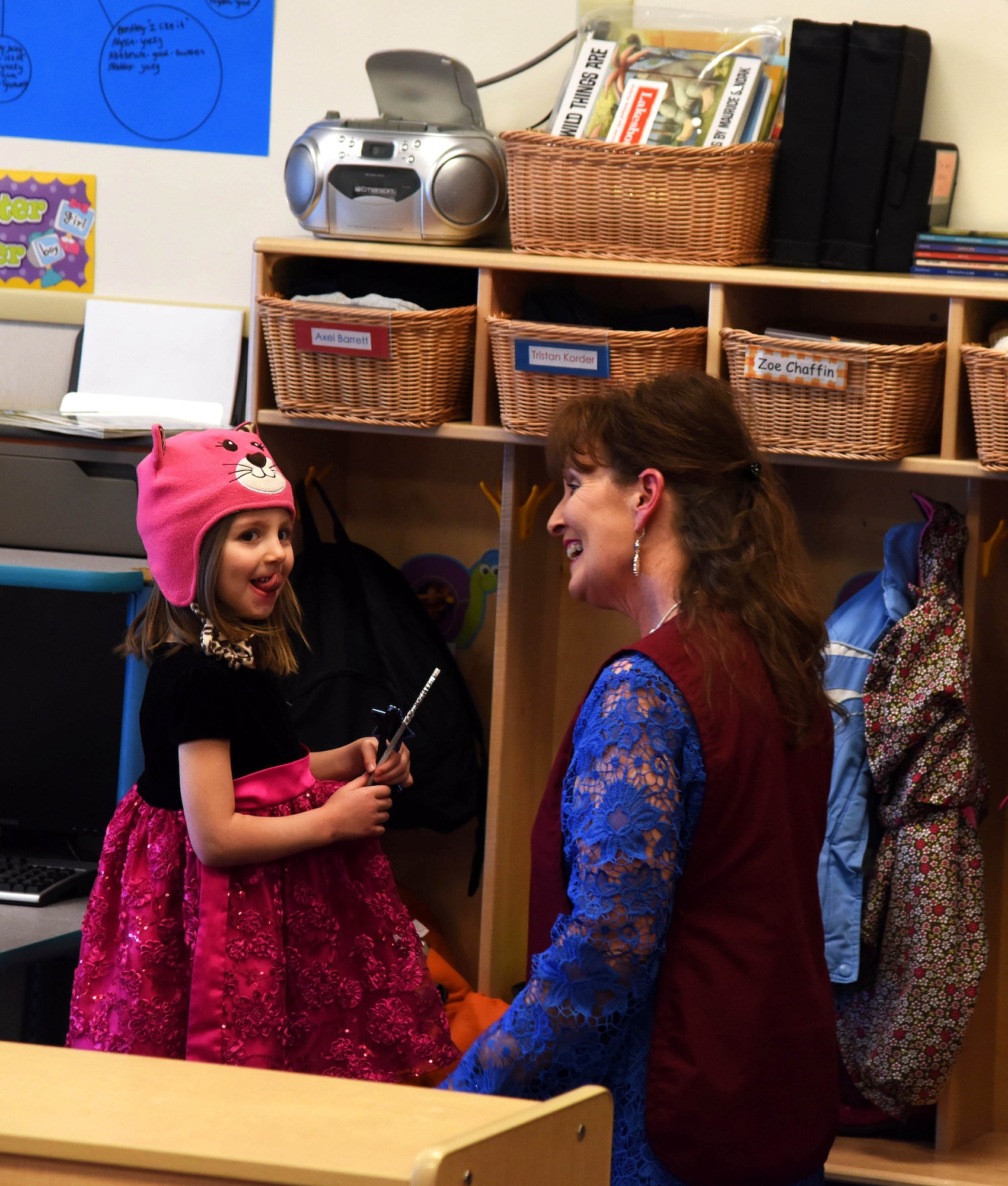 Tamara Carlyon, 341st Force Support Squadron education technician, right, helps a child put on her cold-weather clothing before going outside during a classroom session at the Child Development Center at Malmstrom Air Force Base, Mont., Feb. 11. Carlyon will receive $500 to implement her ideas for a classroom enhancement project with her students.  (U.S. Air Force photo/Airman Collin Schmidt)  