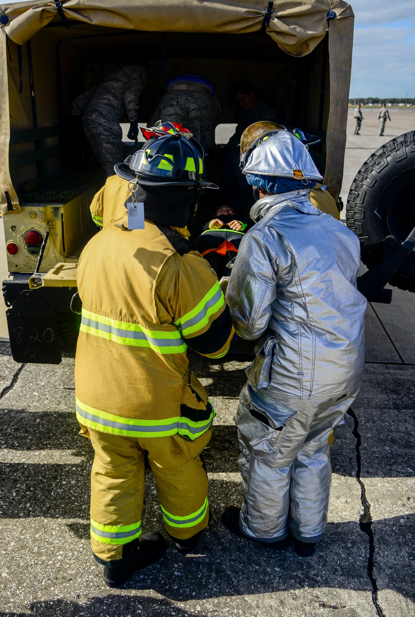 Firefighters assigned to the 6th Civil Engineer Squadron, load a “wounded” victim into the Humvee after a simulated aircraft crash during a major accident response exercise (MARE) at MacDill Air Force Base, Fla., Feb. 8, 2016. Emergency response personnel conducted the MARE to prepare for any mishaps that may occur during the Tampa Bay Air Show scheduled to take place March 19 and 20. (U.S. Air Force photo by Staff Sgt. Melanie Hutto)