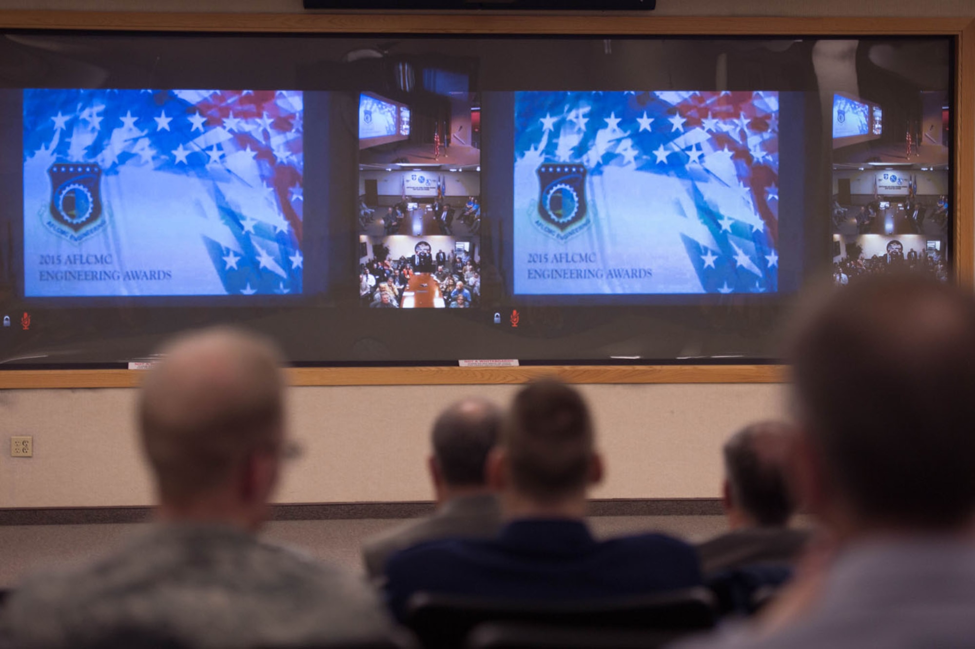 Engineering and technical personnel from Hanscom Air Force Base, Mass., wait for the start of the 2015 Air Force Life Cycle Management Center Engineering Awards ceremony, Feb. 16. The ceremony was presented via video teleconference from Wright-Patterson AFB, Ohio, to various operating locations, including Hanscom.  (U.S. Air Force photo by Jerry Saslav)