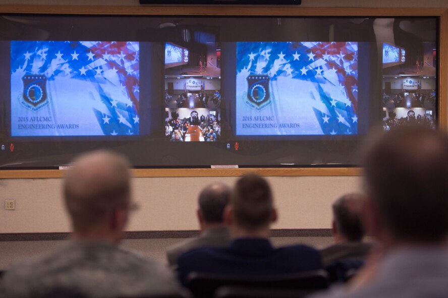 Engineering and technical personnel from Hanscom Air Force Base, Mass., wait for the start of the 2015 Air Force Life Cycle Management Center Engineering Awards ceremony, Feb. 16. The ceremony was presented via video teleconference from Wright-Patterson AFB, Ohio, to various operating locations, including Hanscom.  (U.S. Air Force photo by Jerry Saslav)