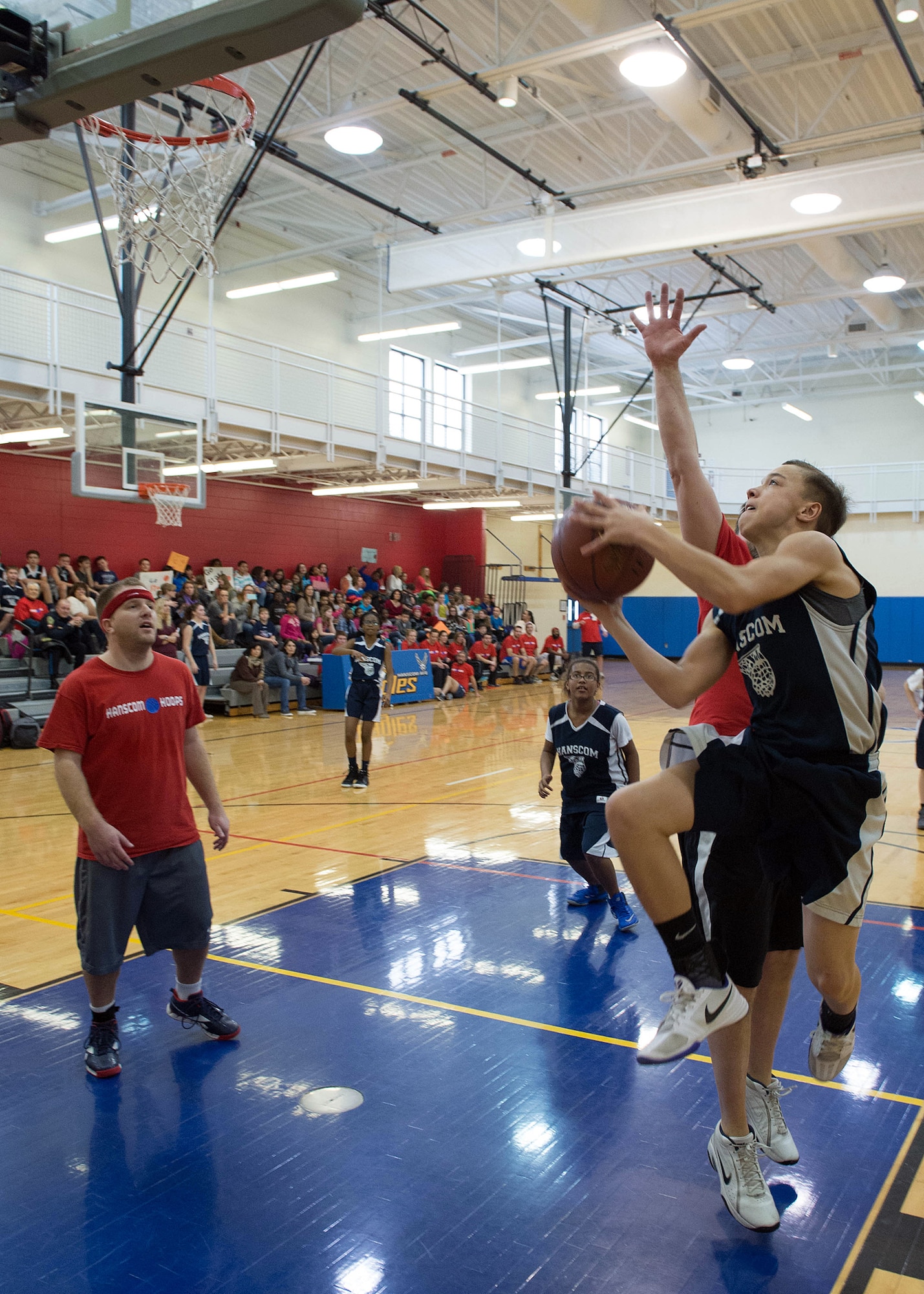 Ben Millican, a Hanscom Middle School student, drives to the basket during a student versus faculty basketball game at the Hanscom Sports and Fitness Center Feb. 12. The faculty team won the game 57 to 47. (U.S. Air Force photo by Jerry Saslav)