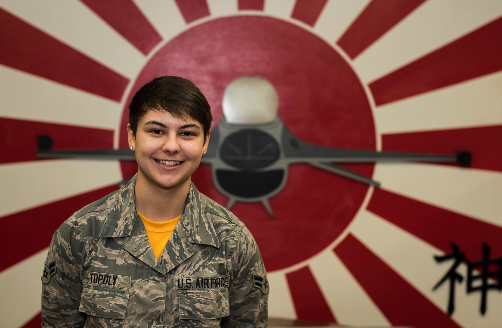 U.S. Air Force Airman 1st Class Lexis Topoly, an Intelligence Analyst with the 14th Fighter Squadron, poses for a Wild Weasel of the Week portrait at Misawa Air Base, Japan, Feb. 12, 2016. Topoly was recognized as the Wild Weasel of the Week by the 14th FS for her superior performance, outstanding work ethic and overall good conduct and discipline. Topoly hails from Akron, Ohio. (U.S. Air Force photo by Senior Airman Brittany A. Chase)