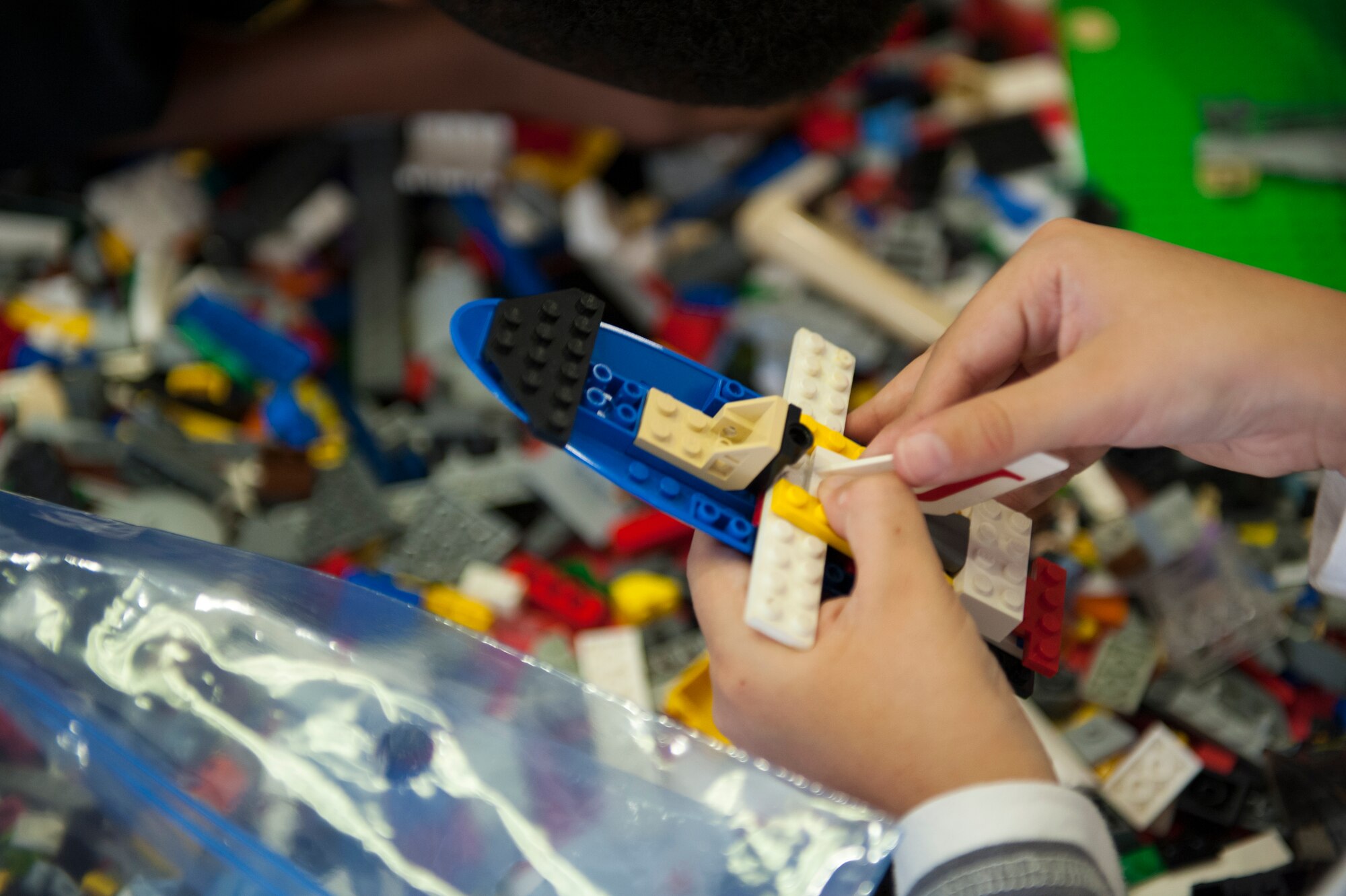 A child pieces together Legos, the material for this years Master Builder Challenge, Feb 13, 2016, at Kadena Air Base, Japan. The Lego Master Builder Challenge, hosted by Air Force Association Keystone Chapter 502, was created to inspire youth to apply science, technology, engineering and math to real world challenges. (U.S. Air Force photo by Airman Zackary A. Henry)