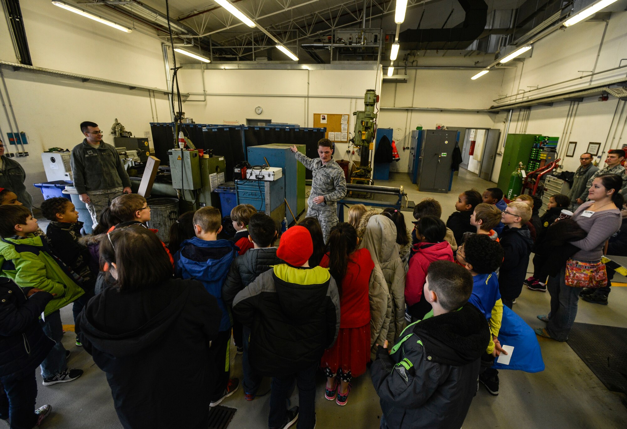 Students from Ramstein Intermediate School gather for a presentation at the 786th Civil Engineer Squadron heavy repair and construction flight Feb. 12, 2016, at Ramstein Air Base, Germany.  Airmen at the 786th CES demonstrated how electricity is conducted, how to shape metal and how to open a safe. (U.S. Air Force photo/Senior Airman Nicole Sikorski) 