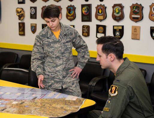 U.S. Air Force Airman 1st Class Lexis Topoly, an Intelligence Analyst with the 14th Fighter Squadron, gives an intel brief to 1st Lt. James Newton, an F-16 Fighting Falcon pilot with the 14th FS at Misawa Air Base, Japan, Feb. 12, 2016.Topoly daily mission consists of providing tactical level intelligence to pilots and assist in mission planning requirements. Topoly hails from Akron, Ohio. (U.S. Air Force photo by Senior Airman Brittany A. Chase)