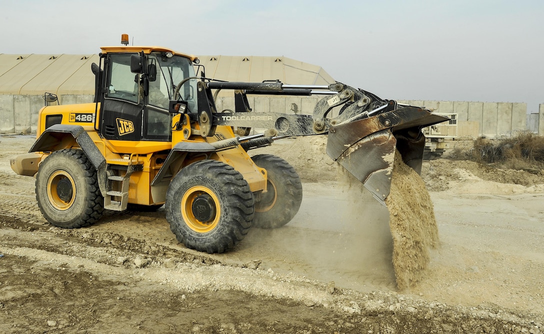 Air Force Staff Sgt. Richard Bonham operates heavy equipment while building the foundation for a new road on Bagram Airfield, Afghanistan, Feb. 9, 2016. Bonham is assigned to the 455th Expeditionary Civil Engineers Squadron. The road will connect portions of the flight line service roads and alleviate additional trips through security checkpoints, while improving traffic efficiency for maintenance vehicles. Air Force photo by Tech. Sgt. Nicholas Rau