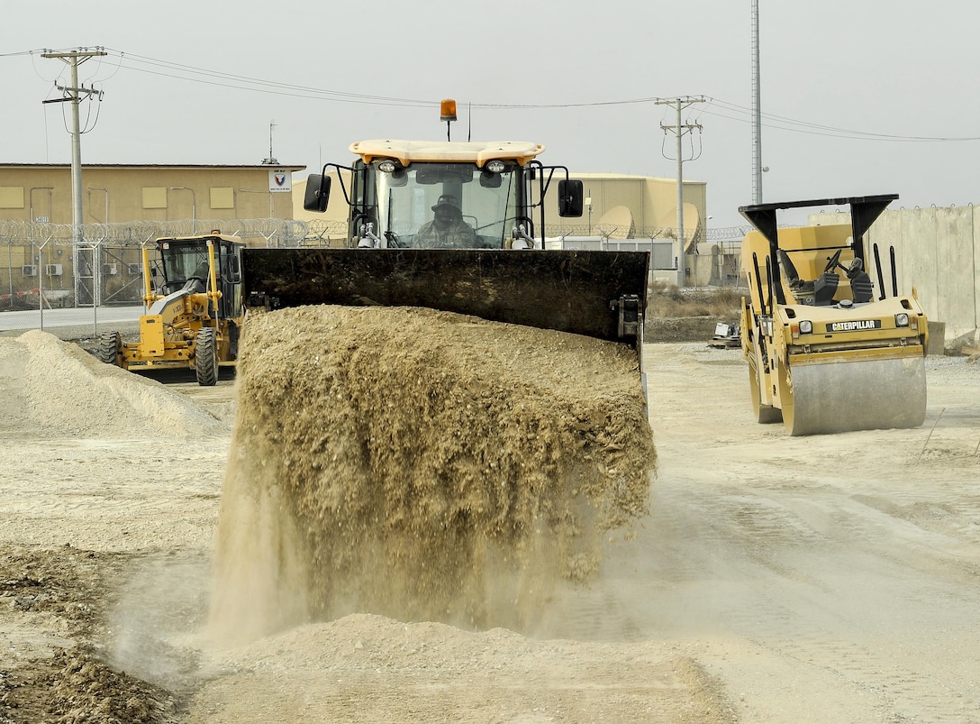 Air Force Staff Sgt. Richard Bonham operates heavy equipment to dump dirt that will be leveled while building the foundation for a new road on Bagram Airfield, Afghanistan, Feb. 9, 2016. Bonham is assigned to the 455th Expeditionary Civil Engineers Squadron. Air Force photo by Tech. Sgt. Nicholas Rau