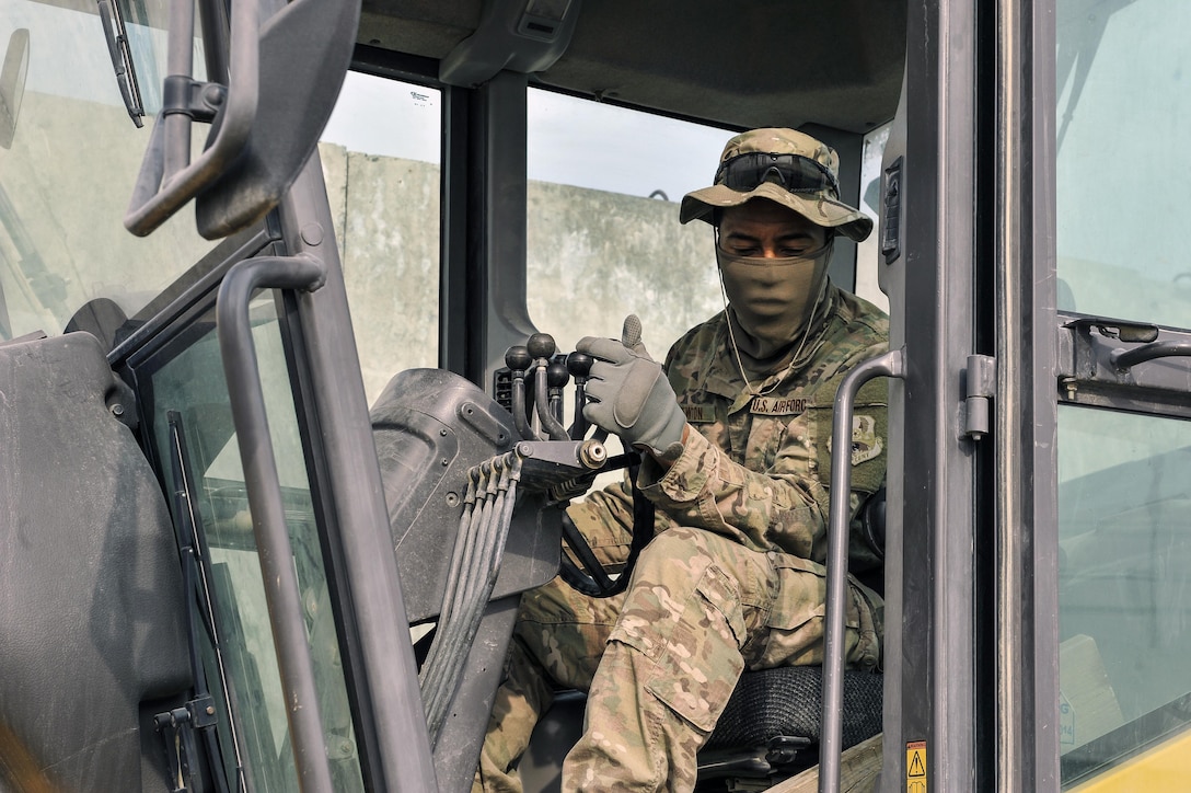 Air Force Senior Airman Xavier Newton operates road grader to level out dirt and gravel while building the foundation for a new road on Bagram Airfield, Afghanistan, Feb. 9, 2016. Newton is assigned to the 455th Expeditionary Civil Engineers Squadron. Air Force photo by Tech. Sgt. Nicholas Rau
