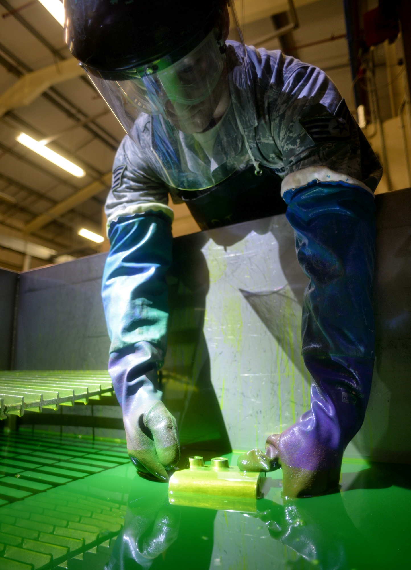 U.S. Air Force Staff Sgt. Joel Kelehar, 100th Maintenance Squadron non-destructive inspection craftsman, immerses a KC-135 Stratotanker accumulator into fluorescent dye penetrant Feb. 3, 2016, on RAF Mildenhall, England. Regular inspections ensure aircrafts are in operating condition to complete everyday missions. (U.S. Air Force photo by Senior Airman Christine Halan/Released)
