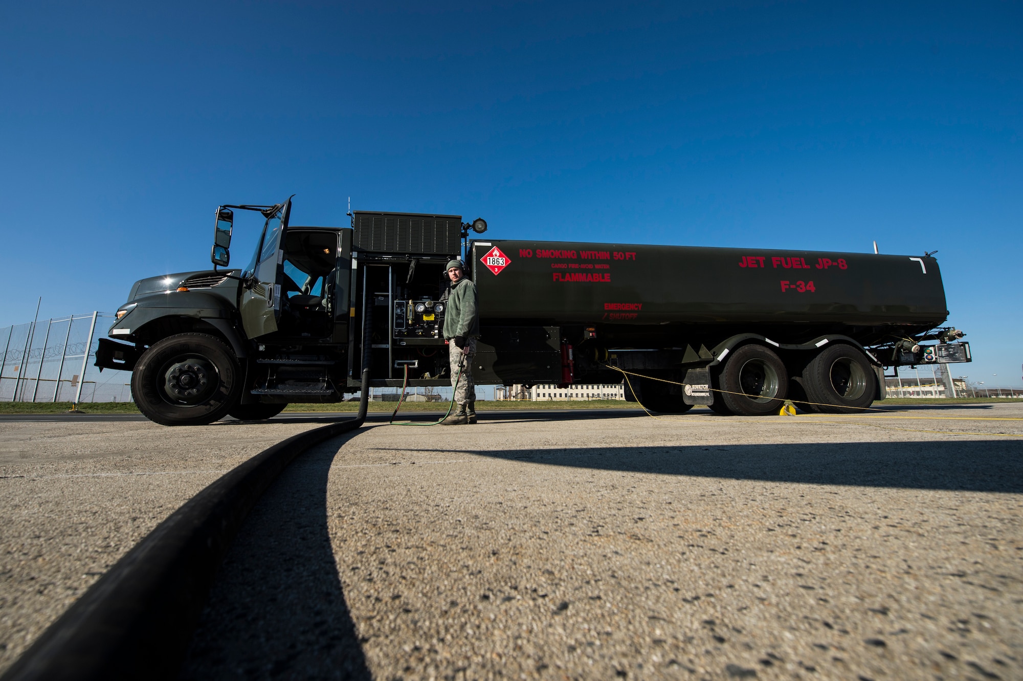 U.S. Air Force Airman Ein Odgers, a 52nd Logistics Readiness Squadron fuels distribution operator, pumps fuel into a returning 480th Fighter Squadron F-16 Fighting Falcon fighter aircraft at Spangdahlem Air Base, Germany, Feb. 16, 2016. The fuels flight issued more than 15 million gallons of jet fuel to the aircraft of the 52nd Fighter Wing and transient aircraft that passed through the base in 2015. (U.S. Air Force photo by Staff Sgt. Christopher Ruano/Released)