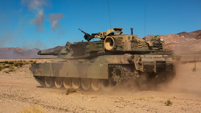 An M1A1 Abrams Main Battle Tank with Company A, 1st Tank Battalion, advances along a road while receiving indirect-fire support from artillery during a Tank Mechanized Assault Course in the Quackenbush Training Area as part of Integrated Training Exercise 2-16 at Marine Corps Air Combat Center Twentynine Palms, Calif.Feb. 9, 2016. ITX is designed to prepare units for combat, under the most realistic conditions possible, focusing on battalion and squad level training. 