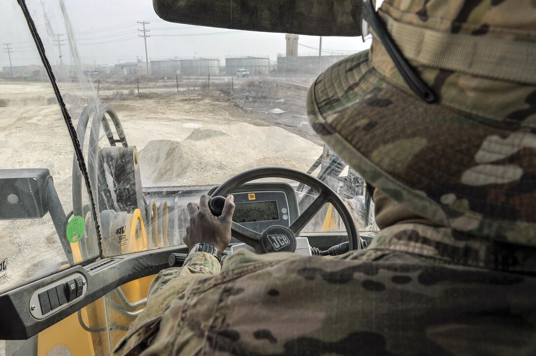 Air Force Staff Sgt. Richard Bonham operates a bulldozer while building the foundation for a new road on Bagram Airfield, Afghanistan, Feb. 9, 2016. Bonham is assigned to the 455th Expeditionary Civil Engineers Squadron. Air Force photo by Tech. Sgt. Nicholas Rau
