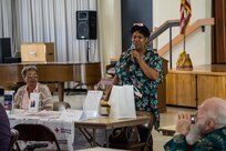 The Southern California Region Survivor Outreach Services support coordinator, Raena Granberry, celebrates lost loved ones with families of fallen service members through expressions of love at the American Gold Star Manor, Long Beach, Calif., Feb. 13, 2016.