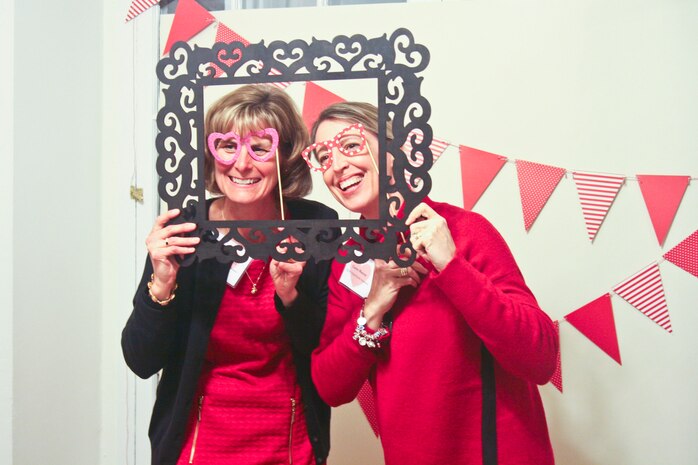Jennifer Maxwell and Carrie Murray pose at the Quantico Officers Spouses Organization Red Dress Gala in support of heart health awareness Feb. 5.