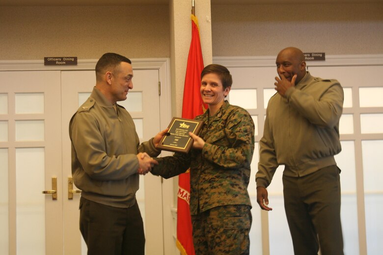 Capt. Bridgett Skelton accepts an award presented by MCBQ Commander Col. Joseph Murray to The Basic School for most improved participation for a large unit in the 2015 Combined Federal Campaign. The award was presented at a ceremony on Feb. 11.