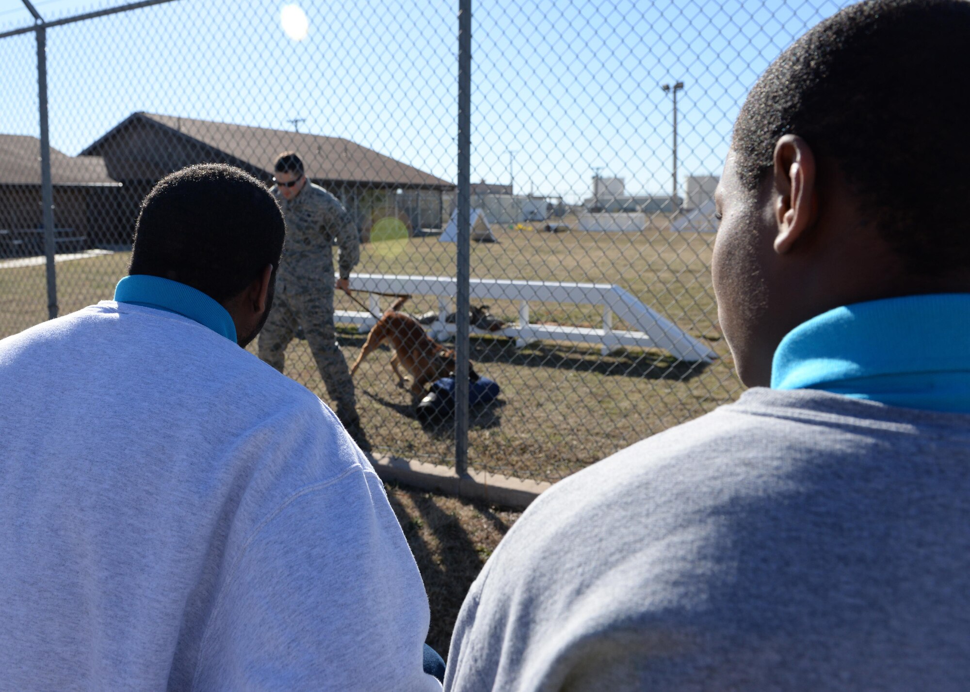 Young men from the Oklahoma Office of Juvenile Affairs watch a military working dog demonstration at Altus Air Force Base, Okla., Feb. 10, 2016. Once a quarter Altus AFB and OJA team up to take tours that focus on juveniles with criminal records by providing opportunities for active duty military to reach out, encourage and help “at risk” youth to see and choose alternative paths. (U.S. Air Force photo by Airman 1st Class Nathan Clark/Released)