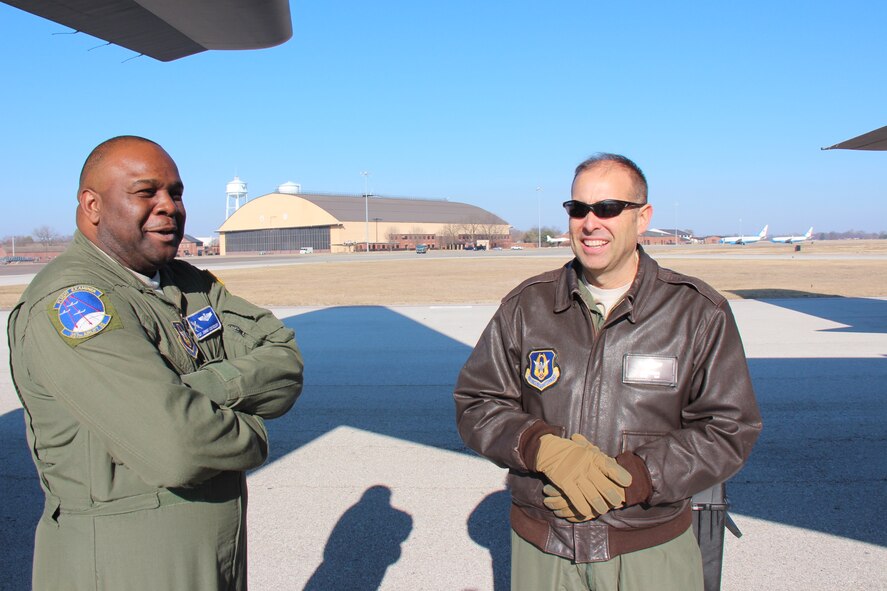 Master Sgt. Johnny Montgomery, flight examiner loadmaster with the 908th Airlift Wing from Maxwell Air Force Base, Alabama, talks during a recent chilly Illinois morning about how to best load equipment and patients with Chief Master Sgt. Jose Tamayo, 932nd Aeromedical Evacuation Squadron, stationed at Scott Air Force Base, Illinois.  The 908th brought a C-130 aircraft in for specialized flight training which benefits both units in practicing their missions.  (U.S. Air Force photo by Maj. Stan Paregien)