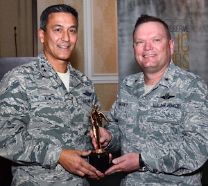 Maj. Gen. Michael Kim, mobilization assistant to the Commander, Air Force Reserve Command, presents the Public Affairs Champion award to Brig. Gen. Samuel "Bo" Mahaney, Air Reserve Personnel Center commander at the Public Affairs Leadership Symposium held Feb. 9, 2016, in Marietta, Ga. This award recognizes commanders who are highly supportive and involved in the Public Affairs career field. (U.S. Air Force photo/Don Peek)